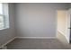 Light-filled bedroom with neutral walls, carpeting, and an open doorway at 1114 Ridgevine Rd, Greenwood, IN 46143