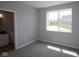 Bedroom with neutral paint, carpeted floors, and a bright window overlooking the yard at 1114 Ridgevine Rd, Greenwood, IN 46143