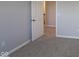 This carpeted bedroom features neutral colors and an adjoining bathroom at 1114 Ridgevine Rd, Greenwood, IN 46143