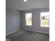 This cozy bedroom features neutral carpet, paint, and two bright windows at 1114 Ridgevine Rd, Greenwood, IN 46143