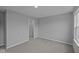 Neutral bedroom with plush gray carpet, closet and a window at 1114 Ridgevine Rd, Greenwood, IN 46143