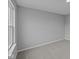 Neutral bedroom featuring plush gray carpet and a large window at 1114 Ridgevine Rd, Greenwood, IN 46143