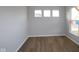 Well-lit room featuring neutral walls and modern vinyl wood-look flooring at 1114 Ridgevine Rd, Greenwood, IN 46143