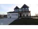 Charming two-story home with a three-car garage and inviting front porch at 1114 Ridgevine Rd, Greenwood, IN 46143