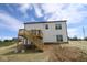 Backyard of a house under construction featuring a wood deck with stairs and freshly laid sod at 1114 Ridgevine Rd, Greenwood, IN 46143