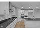 Well-lit kitchen featuring white cabinets, granite countertops, and stainless steel appliances at 1114 Ridgevine Rd, Greenwood, IN 46143