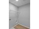 Efficient laundry room with hookups, wire shelving, and modern wood-look flooring at 1114 Ridgevine Rd, Greenwood, IN 46143