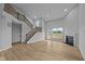 Bright, open living room with a fireplace, large windows, and a staircase at 1114 Ridgevine Rd, Greenwood, IN 46143