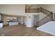 Open-concept living space with high ceilings, hardwood floors, and staircase at 1114 Ridgevine Rd, Greenwood, IN 46143
