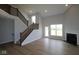 Spacious living room featuring a fireplace, hardwood floors, staircase, and natural light at 1114 Ridgevine Rd, Greenwood, IN 46143