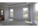 Bright main bedroom with tray ceilings, neutral color, and large windows at 1114 Ridgevine Rd, Greenwood, IN 46143