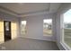 Spacious main bedroom with tray ceiling, neutral walls, carpet and large windows at 1114 Ridgevine Rd, Greenwood, IN 46143