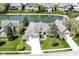 Aerial view of a home showing the backyard pond, green lawn, mature trees, and three car garage at 11862 Stoney Bay Cir, Carmel, IN 46033