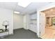 Clean basement area with white cabinets, sink, and access to a bathroom at 11862 Stoney Bay Cir, Carmel, IN 46033