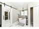 Relaxing bathroom features a freestanding tub with modern fixtures and bright lighting at 11862 Stoney Bay Cir, Carmel, IN 46033