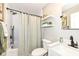 Well-lit bathroom with white tiling, modern fixtures and stylish shelving at 11862 Stoney Bay Cir, Carmel, IN 46033