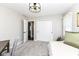 Bright bedroom featuring neutral walls, gray carpet, and a modern light fixture at 11862 Stoney Bay Cir, Carmel, IN 46033
