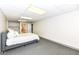 Minimalist basement bedroom showcasing neutral carpet, modern bedding, and recessed lights at 11862 Stoney Bay Cir, Carmel, IN 46033