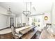 Bright dining room with dark wood floors, a large window, and a view into the foyer at 11862 Stoney Bay Cir, Carmel, IN 46033