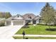 Charming single Gathering home with a well-manicured lawn and three-car garage, perfect for curb appeal at 11862 Stoney Bay Cir, Carmel, IN 46033