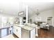 Open kitchen featuring a large island with seating and views into living room at 11862 Stoney Bay Cir, Carmel, IN 46033
