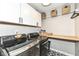 Efficient laundry room featuring modern washer/dryer and white cabinets for ample storage, with a convenient folding counter at 11862 Stoney Bay Cir, Carmel, IN 46033