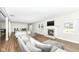 Bright and airy living room with hardwood floors, fireplace, and large windows at 11862 Stoney Bay Cir, Carmel, IN 46033