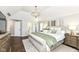 Comfortable main bedroom features an accent wall, decorative lighting, and ample natural light at 11862 Stoney Bay Cir, Carmel, IN 46033