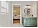 Stylish bathroom featuring an updated vanity with white marble top and round mirror with light at 125 W Noble St, Lebanon, IN 46052