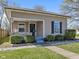 Charming home featuring landscaped front yard, covered porch, and neutral-toned siding at 125 W Noble St, Lebanon, IN 46052
