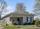 Inviting home with covered porch, stone accents, and a well-maintained, lush green lawn at 125 W Noble St, Lebanon, IN 46052