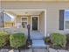 Charming front porch with stone base, rocking chair, and a welcoming entrance with wreath at 125 W Noble St, Lebanon, IN 46052