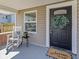 Inviting front porch with a rocking chair, seasonal flowers, and a decorative welcome mat at 125 W Noble St, Lebanon, IN 46052