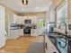 A well-lit kitchen with stainless steel appliances, white cabinets and black countertops at 125 W Noble St, Lebanon, IN 46052