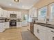 Bright kitchen featuring stainless steel appliances, white cabinets, black countertops and a door to the backyard at 125 W Noble St, Lebanon, IN 46052
