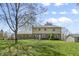 Lush green backyard showcasing a spacious lawn and the rear of the home with a mix of brick and siding at 12867 Andover Dr, Carmel, IN 46033