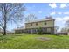 Expansive backyard featuring a well-maintained lawn and a charming two-story brick home, perfect for outdoor activities at 12867 Andover Dr, Carmel, IN 46033
