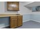 Basement wet bar area featuring wood cabinets and laminate countertop with a sink at 12867 Andover Dr, Carmel, IN 46033
