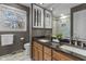Bathroom featuring a double vanity, granite countertop, large mirror and a window with natural light at 12867 Andover Dr, Carmel, IN 46033