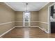 Formal dining room with hardwood floors, a chandelier, and neutral-toned walls, ready for entertaining at 12867 Andover Dr, Carmel, IN 46033