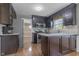 Kitchen featuring stainless steel appliances, stone countertops, and warm wood flooring at 12867 Andover Dr, Carmel, IN 46033