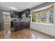 Bright eat-in kitchen with natural light, stainless appliances, and warm wood flooring at 12867 Andover Dr, Carmel, IN 46033