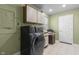 Well-lit laundry room featuring modern appliances and convenient storage space at 12867 Andover Dr, Carmel, IN 46033