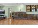 Bright living room featuring a brick fireplace, built-in shelving, and hardwood floors at 12867 Andover Dr, Carmel, IN 46033