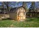 Shed sitting on the grass surrounded by trees and foliage at 12867 Andover Dr, Carmel, IN 46033