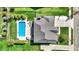 Aerial view showcasing backyard inground pool, lounge furniture, manicured lawn, and driveway at 13836 Fieldcrest Dr, McCordsville, IN 46055