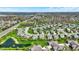 Overhead view of a picturesque residential area with a lake, green spaces, and well-maintained homes near a highway at 13836 Fieldcrest Dr, McCordsville, IN 46055