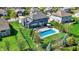 Aerial view showcases blue home with an in-ground pool and manicured lawn at 13836 Fieldcrest Dr, McCordsville, IN 46055