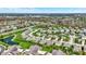 Scenic aerial view of a vibrant residential community with a lake, lush greenery, and well-designed homes at 13836 Fieldcrest Dr, McCordsville, IN 46055