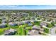 Aerial view of homes, green lawns, and landscaping, with a sparkling blue swimming pool at 13836 Fieldcrest Dr, McCordsville, IN 46055